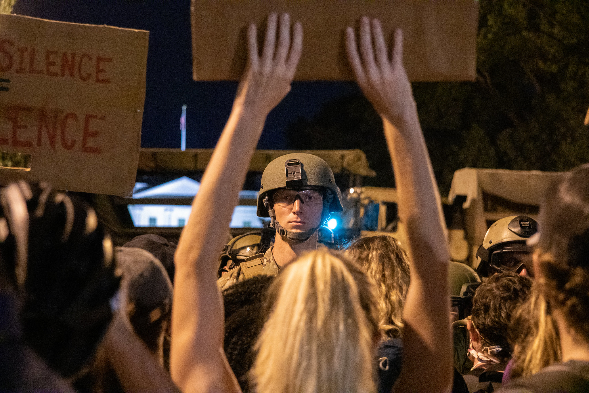 BLM Protests in DC - a member of the military is centered in the frame, standing in front of protesters