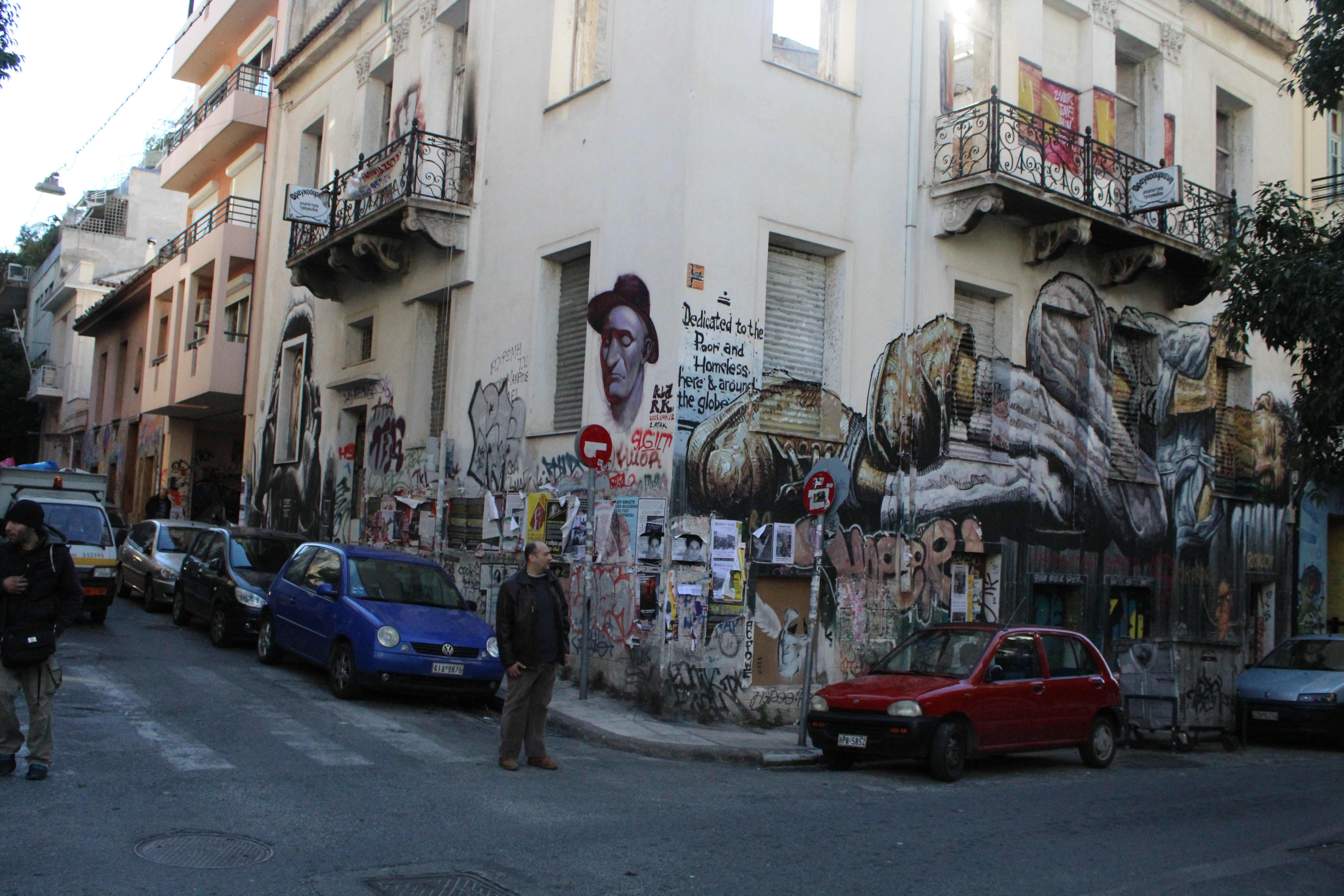 Street art in Exarchia that reads "Dedicated to the Poor and Homeless Here and Around the World"