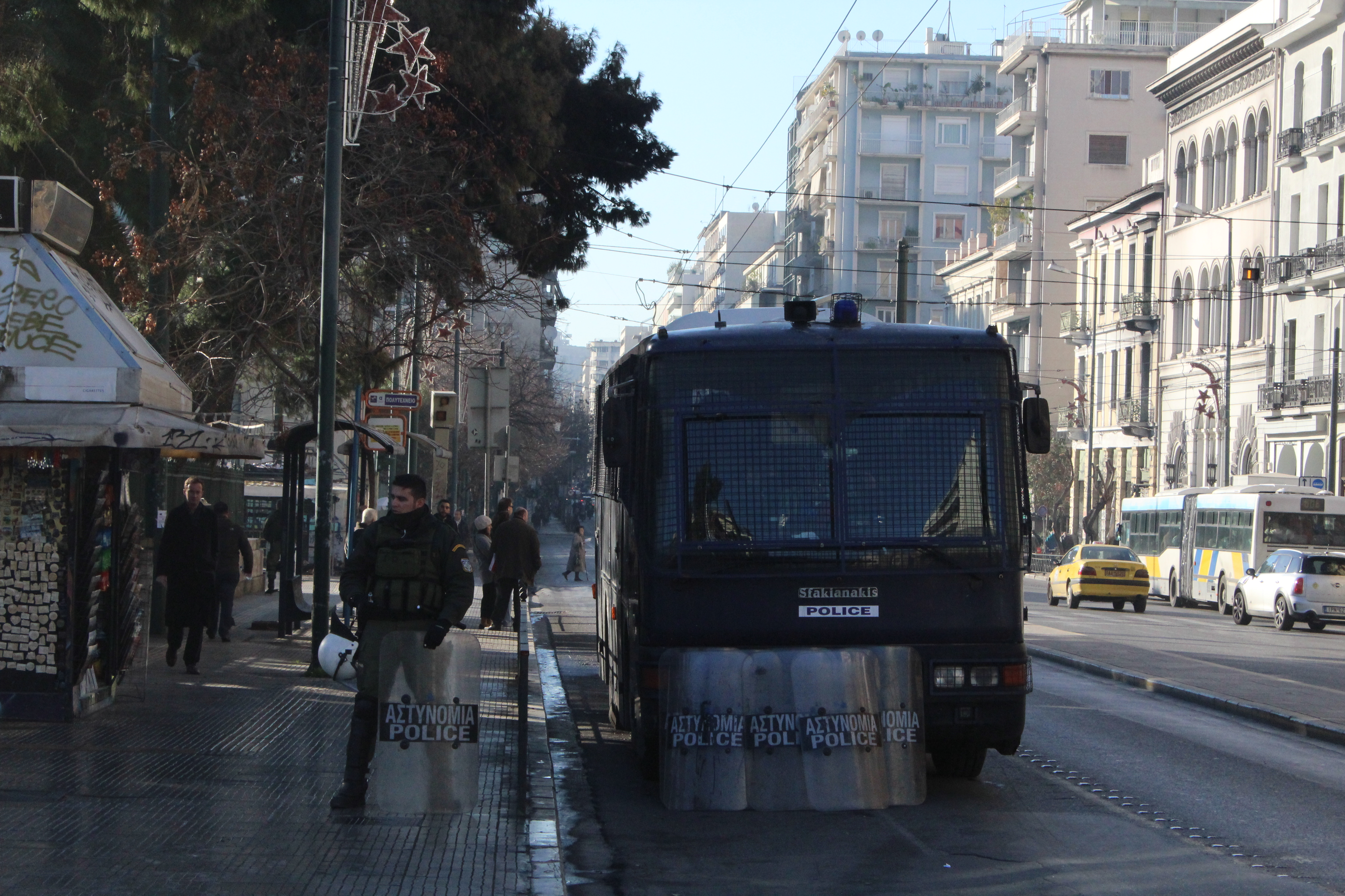 A heavy police presence sits outside Exarchia