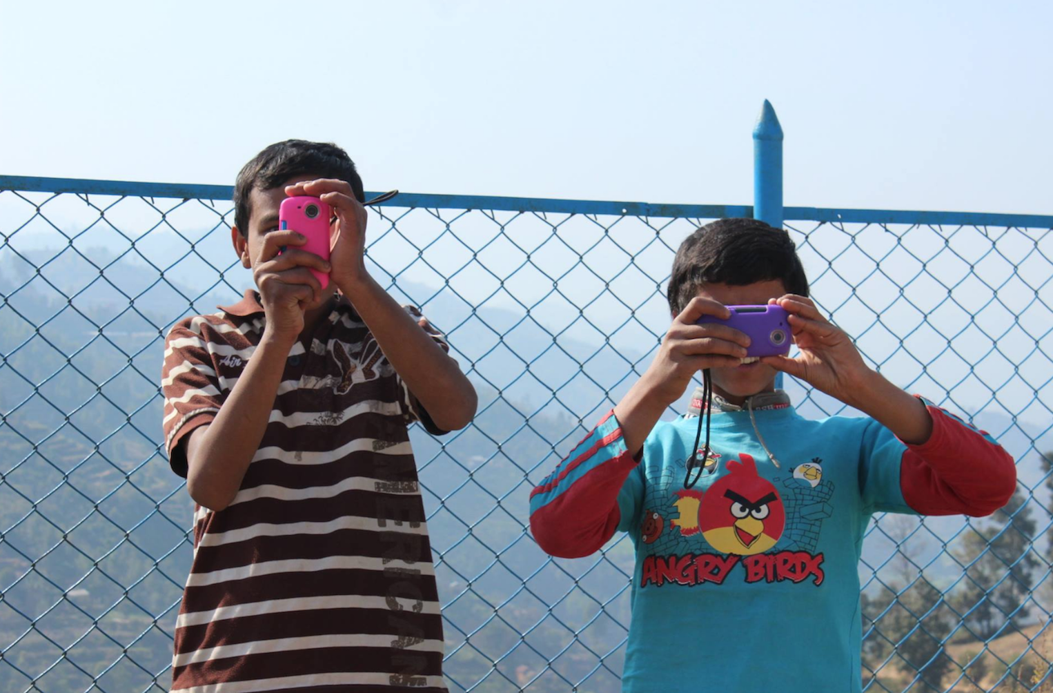 Two kids taking videos in Nepal with NGO Filmmakers Without Borders, Image Credit: Beth Grannis 