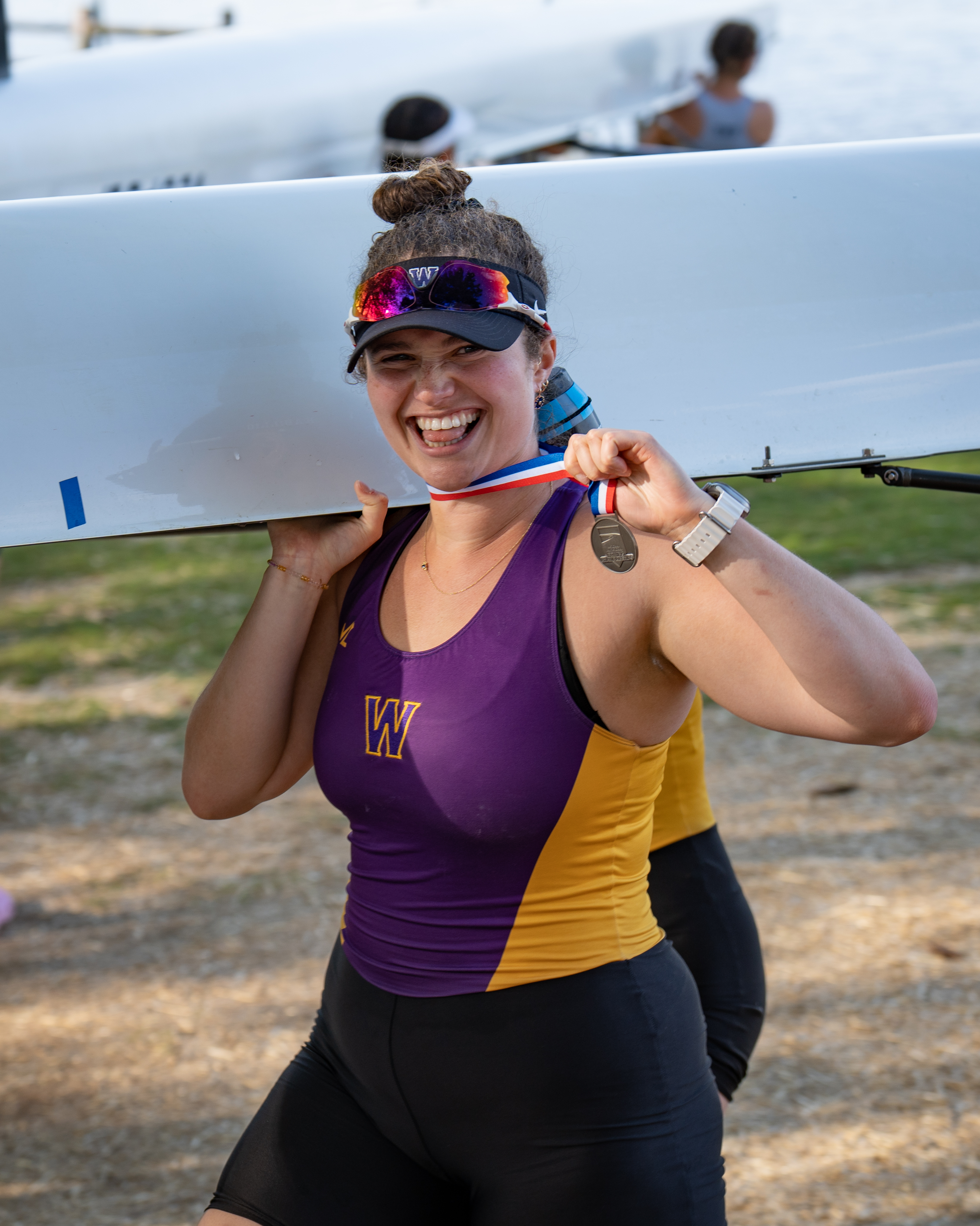 Rower holding a medal