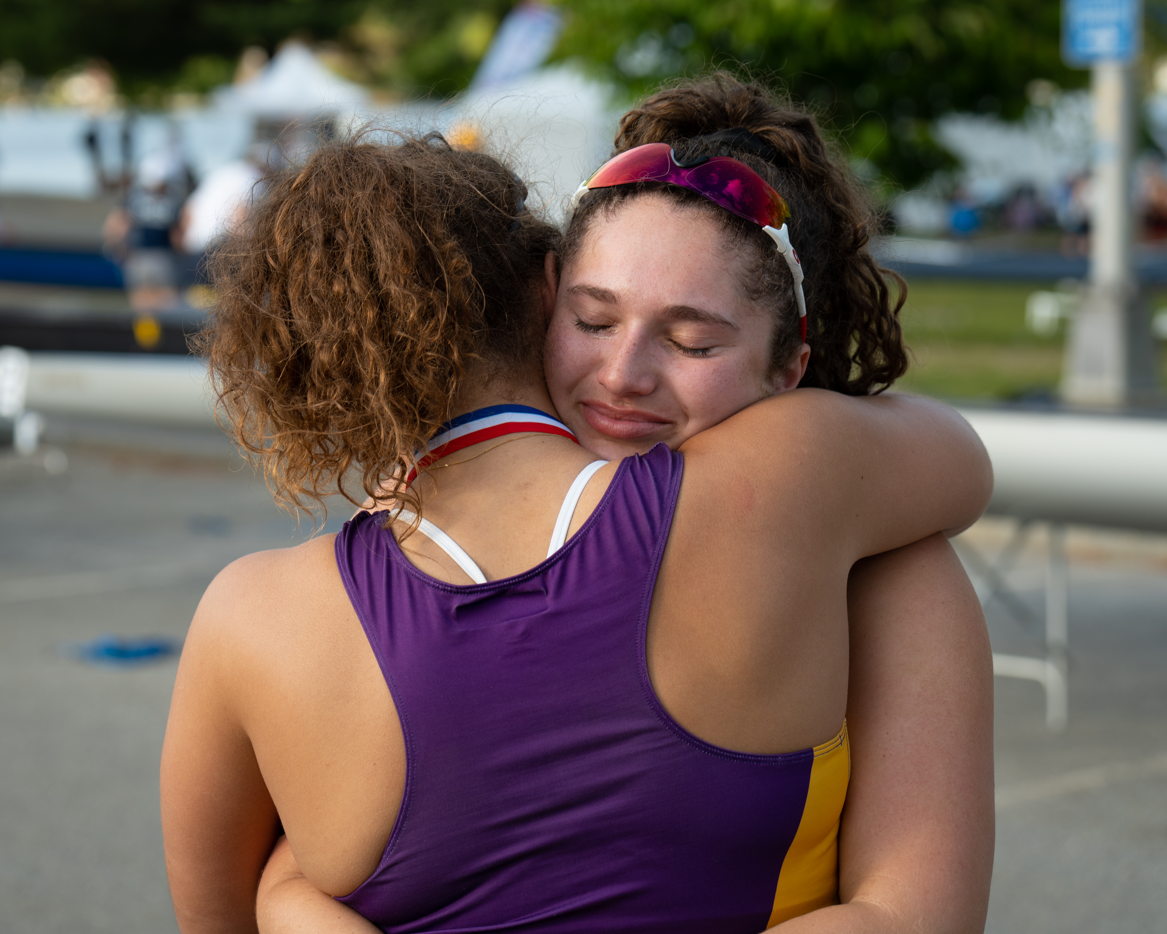 Two rowers hugging after a race
