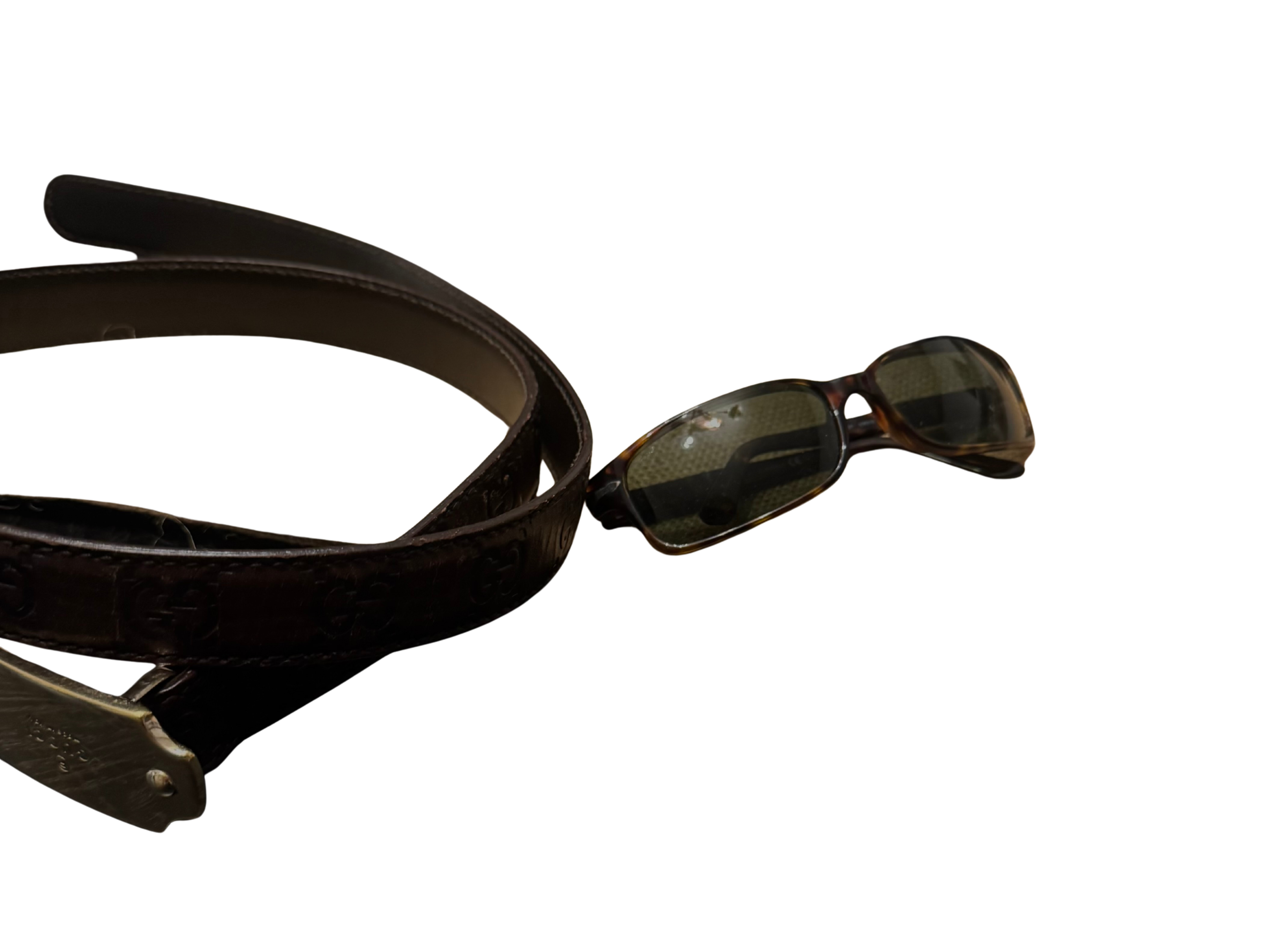 Sunglasses and leather belt with gold detail. /Image Credits: Roger Griswold III