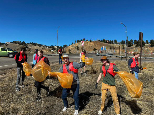 Members of the Alpha Tau Omega fraternity in Golden, Colorado, participate in a trash pick up event.