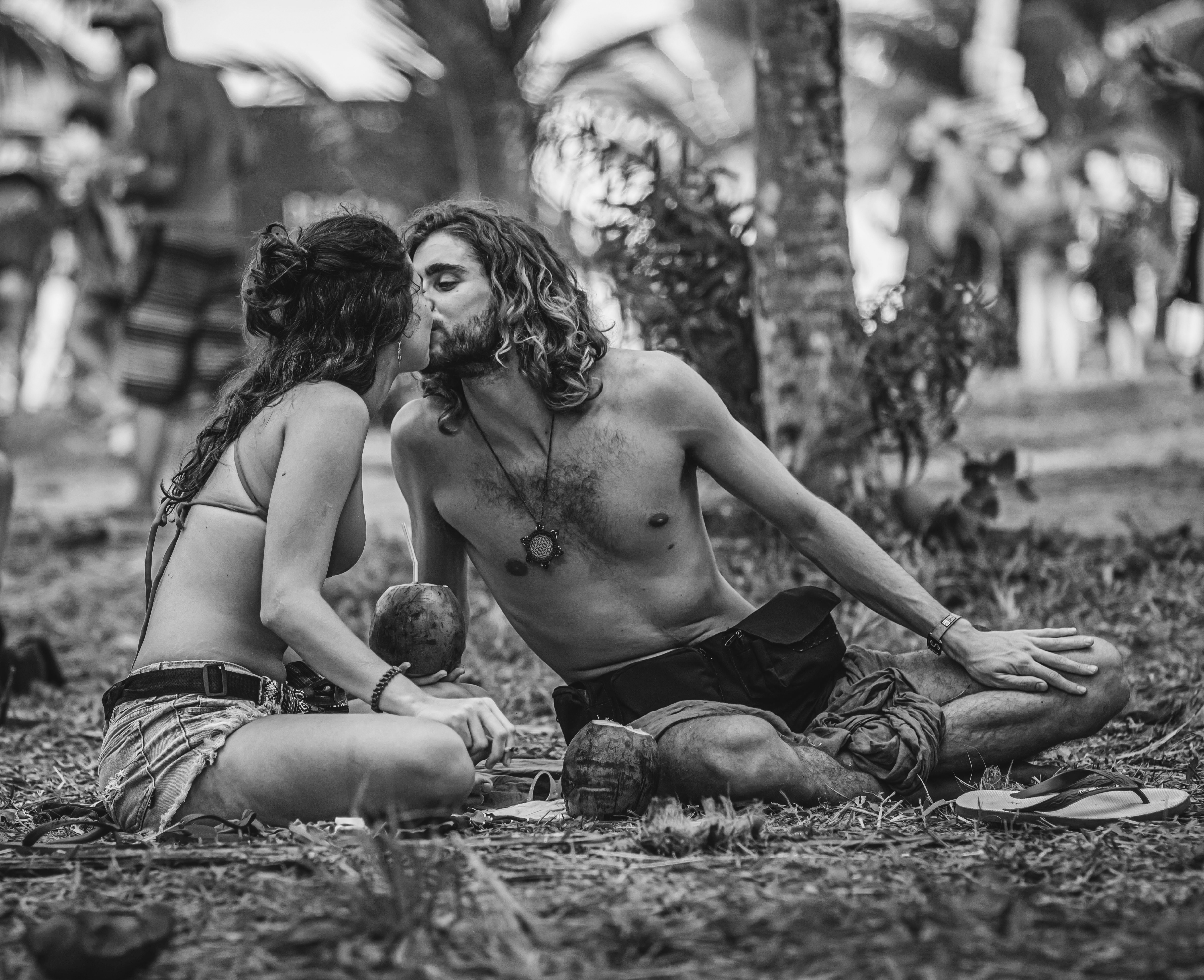 Couple in Tropics Sitting and Kissing