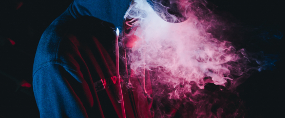 Man in hoody vaping -- Photo by Wild Vibes on Unsplash