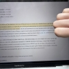 Student dissapproving of attendance policy by putting a thumbs down in front of photo of the policy