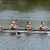 A competitive crew rowing on the water.