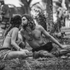 Couple in Tropics Sitting and Kissing