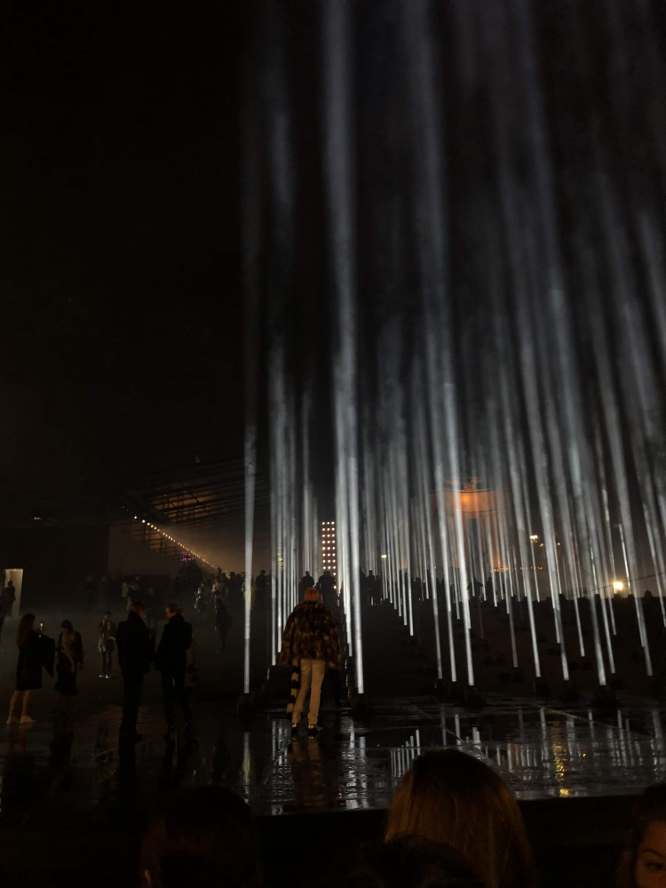 Image shows light beams from the ground, outside Saint Laurent show at Trocadero Gardens