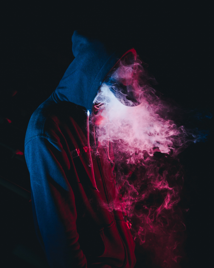 Man in hoody vaping -- Photo by Wild Vibes on Unsplash